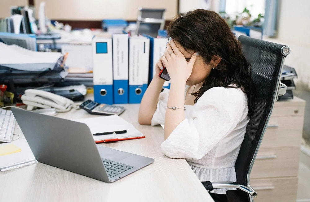 Exhausted office worker experiencing fatigue from prolonged sitting