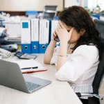 Exhausted office worker experiencing fatigue from prolonged sitting