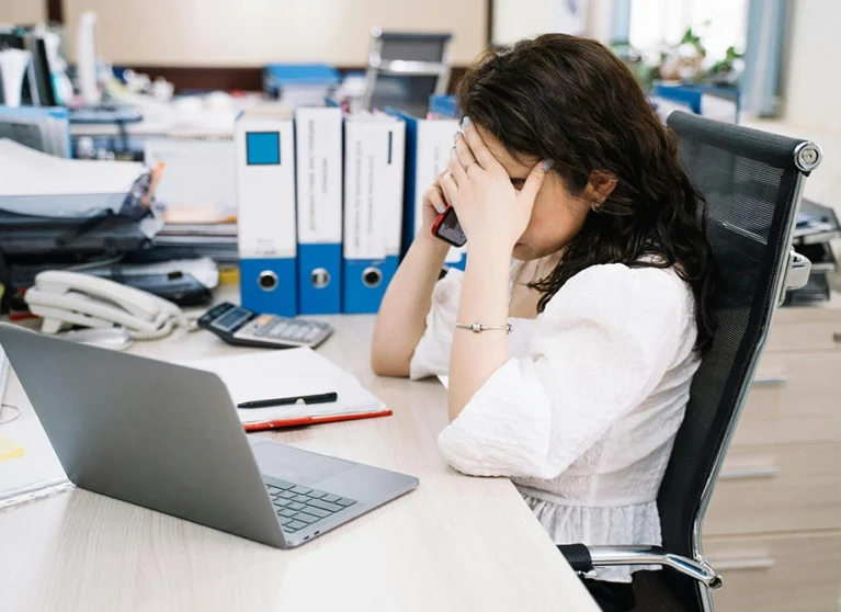 Exhausted office worker experiencing fatigue from prolonged sitting